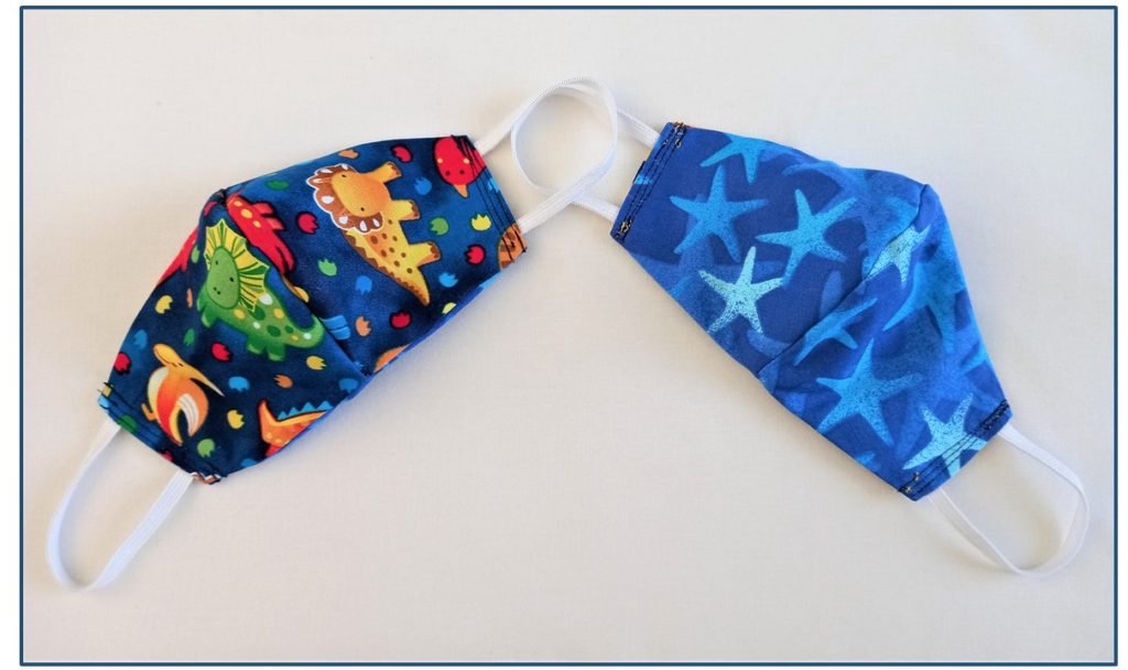 Reusable and reversible cloth face mask for kids in fund Dinosaur and Star fish pattern